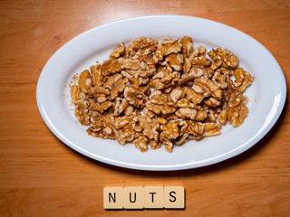 A plate of peeled nuts with the word. Top view
