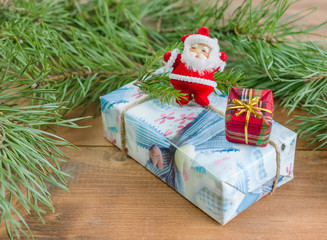 Christmas gift boxes, spruce branches and Santa Claus