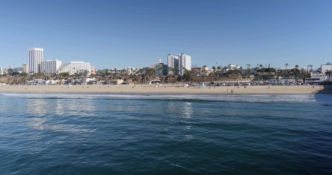 A daytime establishing shot of the Santa Monica beach skyline.  	