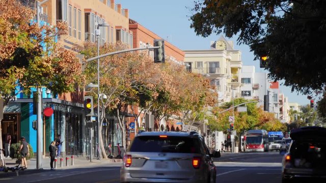 A daytime exterior establishing shot of the business district on Broadway in downtown Santa Monica, California on a sunny winter day.  	