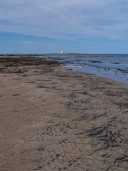 beach in scotland with buildings on island