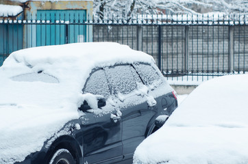 The car is covered in snow and frozen windows.