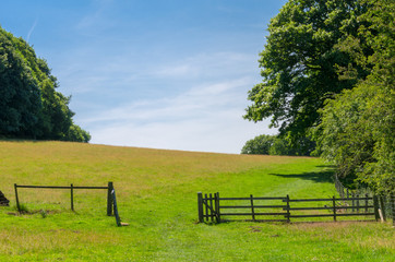 A wooden fence in an idyllic countryside setting in summer. Photo taken in the English Peak...