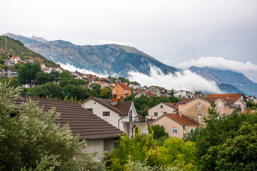 Fototapeta na wymiar Morning fog in village in the mountains in Montenegro, Tivat.