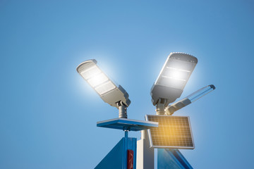 Solar panel with lamp under blue sky for energy power concept.