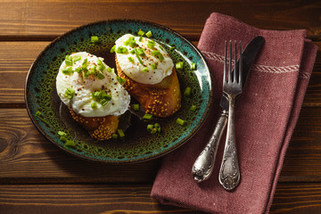 poached eggs on baguette with greens.