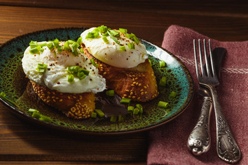 poached eggs on baguette with greens.
