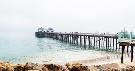 Malibu foggy pier in Southern California, Pacific coast, USA. View on the Pacific Ocean. Copy space...
