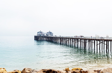 Malibu foggy pier in Southern California, Pacific coast, USA. View on the Pacific Ocean. Copy space...