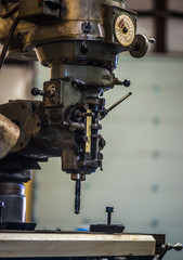 Old heavy duty drill press in fabrication shop