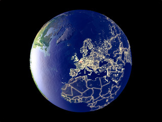 Belgium from space on model of planet Earth with city lights. Very fine detail of the plastic planet surface and cities.