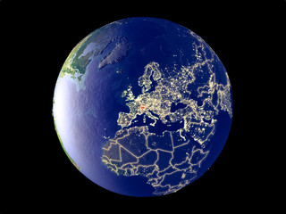 Switzerland from space on model of planet Earth with city lights. Very fine detail of the plastic planet surface and cities.