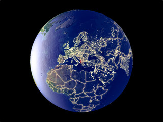Albania from space on model of planet Earth with city lights. Very fine detail of the plastic planet surface and cities.