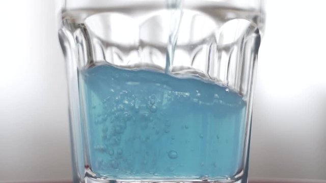 Pouring Blue Isotonic Drink in Slow motion