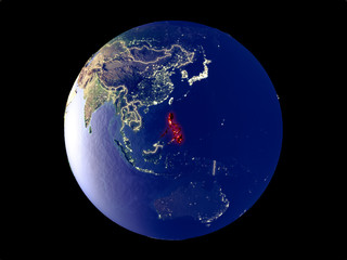 Philippines from space on model of planet Earth with city lights. Very fine detail of the plastic planet surface and cities.