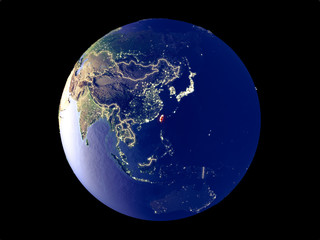 Taiwan from space on model of planet Earth with city lights. Very fine detail of the plastic planet surface and cities.