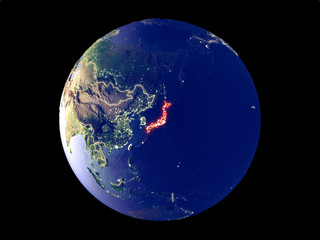 Japan from space on model of planet Earth with city lights. Very fine detail of the plastic planet surface and cities.