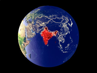 India from space on model of planet Earth with city lights. Very fine detail of the plastic planet surface and cities.