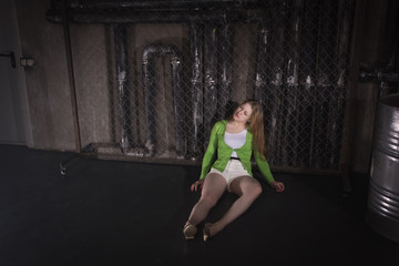  Lifeless unconscious woman lying on a factory floor