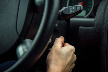 a driver in a car performs tasks necessary to steer the vehicle
