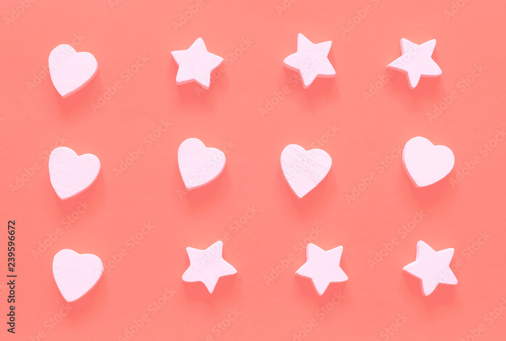 Wall mural Valentines Day concept.Pattern of wooden white heart and star decorations on the background of coral.