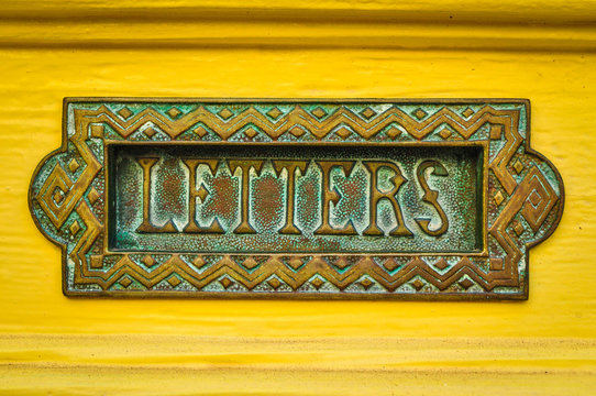 Letter box in yellow door