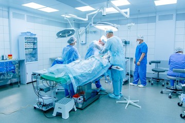 Doctor surgeon performs surgery with a team of surgeons in intensive care