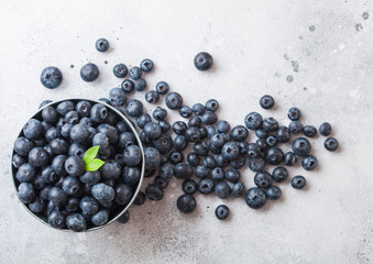 Fresh raw organic blueberries in vintage steel box on stone kitchen background. Top view.