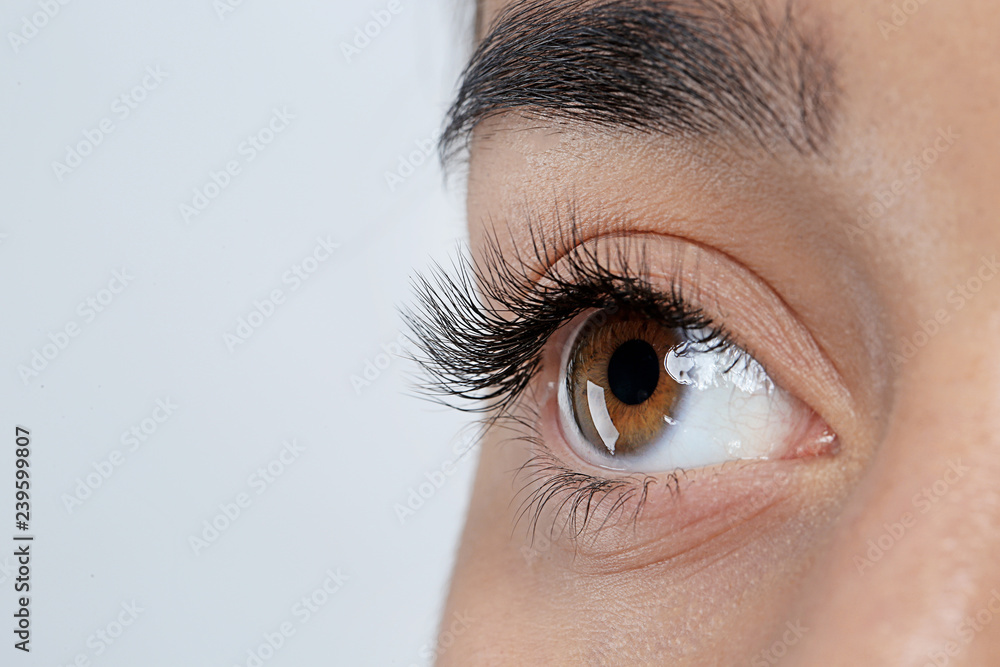 Poster Young woman with beautiful eyelashes on gray background, closeup view