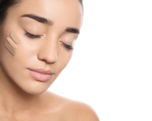 Obraz premium Young woman with different shades of skin foundation on her face against white background