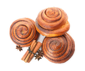 Freshly baked cinnamon rolls with ingredients on white background, top view