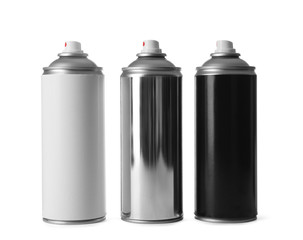 Cans of different spray paints on white background