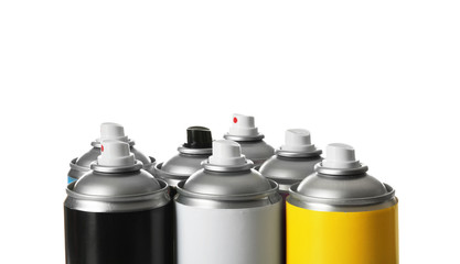 Cans of different spray paints on white background