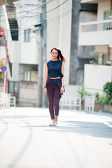 Asian female model poses for pictures on the street