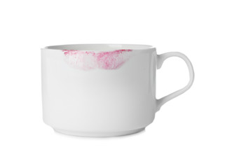 Ceramic cup with lipstick mark on white background