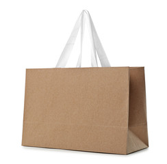 Paper shopping bag with handles on white background. Mockup for design