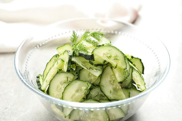 Delicious cucumber salad with dill in bowl on table, closeup