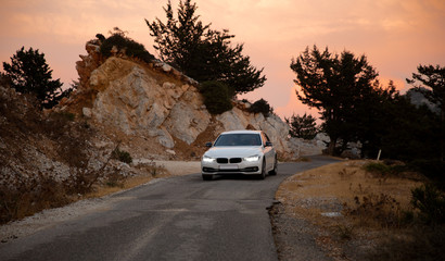 Car in the mountains at sunset