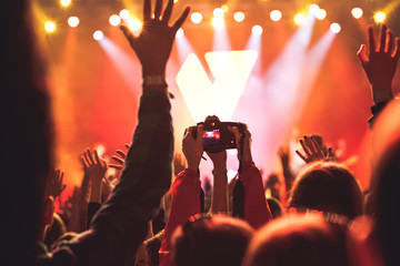 cheering crowd with raised hands at concert - music festival