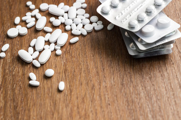 Medicine pills on a wooden texture table