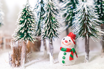 Christmas Winter snowman on snow field in pine tree decorate for Xmas festival.