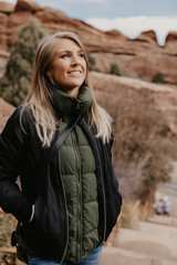 Young Beautiful Modern Caucasian Woman Smiling While Traveling to Red Rocks Park in United States...