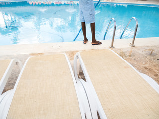 Unrecognizable man cleaning swimming pool