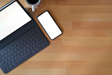 Top view wood desk top mockup tablet with keyboard, blank screen mobile smart phone and copy space
