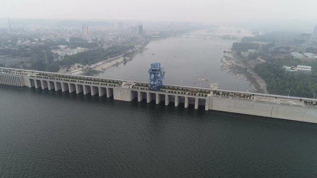Tilting drone shot shows height difference of water level at the Danjiangkou dam and reservoir, hydropower and water diversion project in China