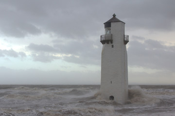 Fototapeta na wymiar Southerness Lighthouse being battered by a heavy storm. Dumfriesshire, Scotland.