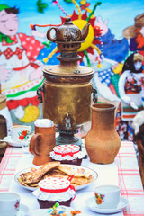 Samovar on the table next to rustic dishes