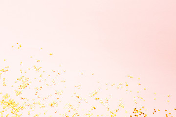 Gold color confetti on pink