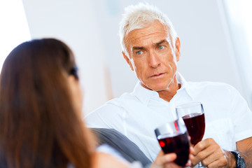 Portrait of a couple having a glass of red wine