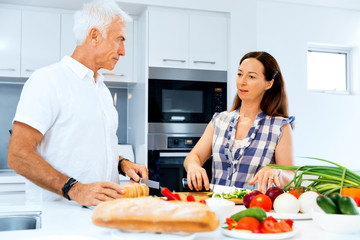 Married couple cooking at home